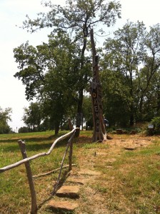 Site of Woody Guthrie's childhood home on W. Birch St., Okemah, Oklahoma. Tree sculpture by Justin Osborn.